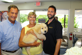 Rick Mellon, Melanie Mellon and Brian Mellon with puppy