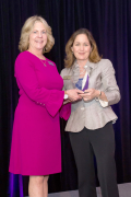 Shelter CDO Cyndi Fields, left, receives an award for years of service from Shelter CEO Linda Oberhaus